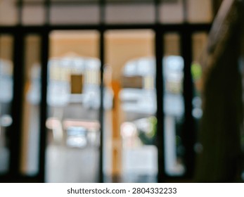 An abstract and intentionally blurred background showcasing the interior of a contemporary building, featuring soft light reflections and indistinct shapes, creating a sense of depth and modern aesth.