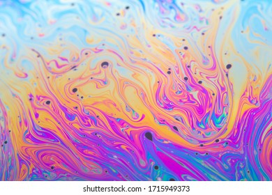 Abstract iridescent background interference light rainbow colors. Soap bubble texture