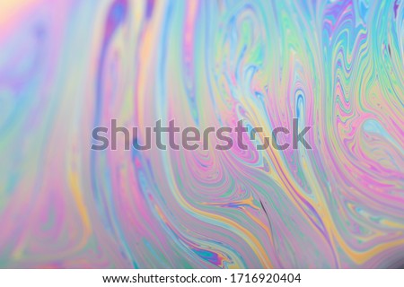 Abstract iridescent light background interference light rainbow colors. Soap bubble texture