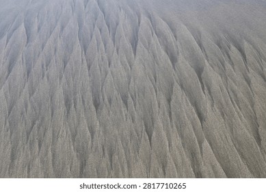 Abstract Iron Sand Patterns Created by Receding Ocean Waves