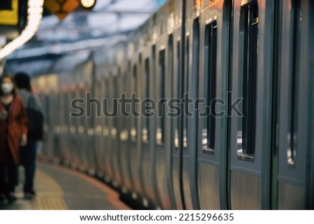 Abstract of Japanese Train stop at platform of train station with passenger boarding and alight the train. Urban commuter and rapid transit in modern city concept.
