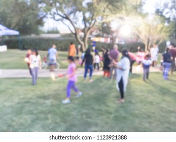 Abstract Kids Having Fun With Sparkler Fireworks And Glow At July 4th Celebration Event In Irving, Texas, USA. Diverse Group Of Local Residents Crowd Celebrate Fourth Of July At Evening