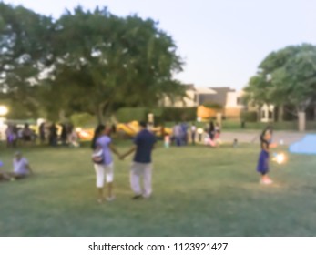 Abstract Kids Having Fun With Sparkler Fireworks And Glow At July 4th Celebration Event In Irving, Texas, USA. Diverse Group Of Local Residents Crowd Celebrate Fourth Of July At Evening