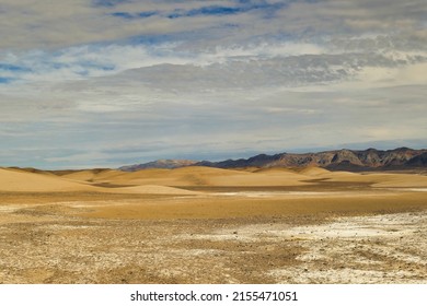 Abstract Landscape Of Dunes And Dark Mountains In The Desert And Salt Flats Between Tecopa And The China Ranch Date Farm, California, Mojave Desert, Inyo County.
