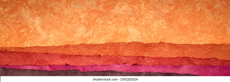 abstract landscape in red tones created with sheets of textured colorful handmade paper, panoramic banner