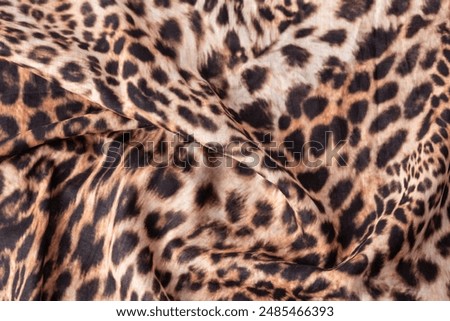Abstract leopard texture background. Cotton fabric with fashionable print. Wild animal print cotton cloth sample.