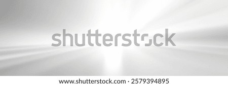 Abstract light burst with soft rays illuminating a white background.
