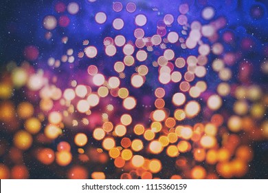 Abstract light celebration background with defocused golden lights for Christmas, New Year, Holiday, party 