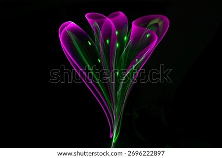 Abstract light form creating the shape of a flower made of luminous trails with selective focus, evoking a futuristic and ethereal feel. Abstract flower lights.