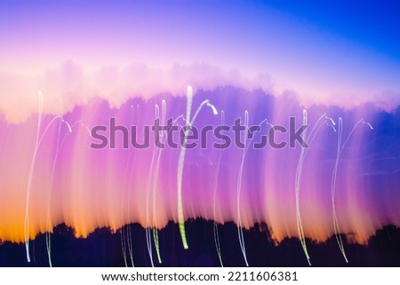 abstract light painting photograph in pinks, blues, and purples. 