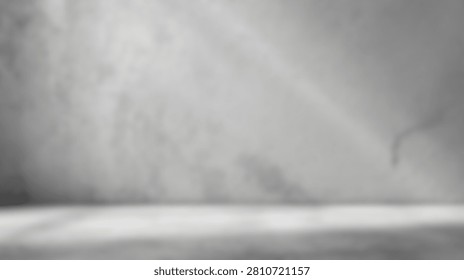 Abstract light rays and shadows create a dramatic atmosphere on a textured concrete studio floor and wall.