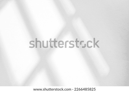 Abstract light reflection and grey shadow from window on white wall background. Gray window shadows and sunshine stripe overlay effect for backdrop and mockup design

