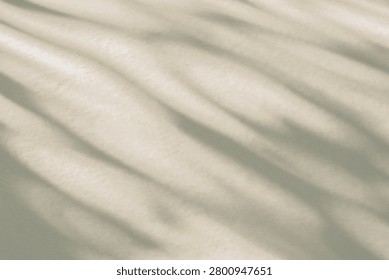 Abstract  light shadow of leaf beige blurred background. Natural diagonal leaves tree branch shadows and sunlight on white wall. Shadow overlay effect foliage mockup