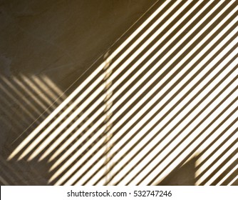 Abstract Of Light And Shadow On Wall Through Window Blind Shutter.Shadow On Wall,the Parallel Lines Of Light And Reflection Provide Interesting Abstract Interior Character.