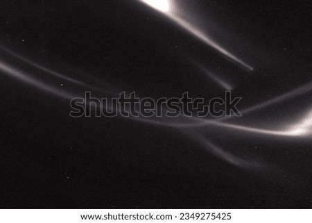 Abstract light streaks flares glowing in dark with vintage film grain texture for background, light effect wallpaper