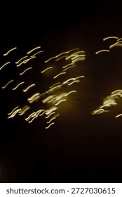 Abstract light trails creating dynamic bokeh patterns against a dark background, perfect for artistic and creative concepts.