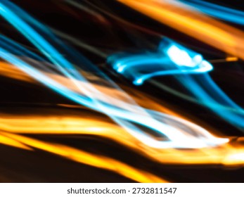Abstract light trails creating dynamic flowing lines and glowing streaks on a dark background, representing digital data, energy, speed, and modern technology concepts