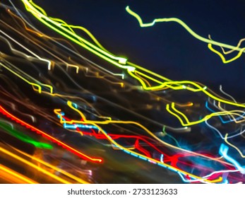Abstract light trails creating a dynamic and colorful visual representation of technology, speed, and energy flow during nighttime, showcasing movement and modern concepts for graphic design