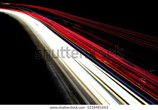 Abstract light trails on\
highway at night