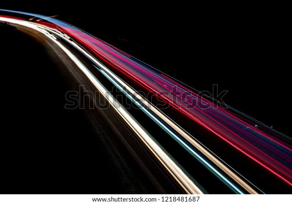Abstract light trails on\
highway at night