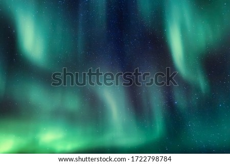 Abstract lines of aurora borealis in the night sky full of stars