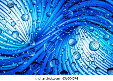 Abstract lines through drops of water on a glass macro