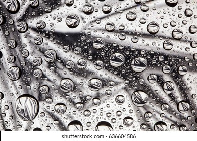 Abstract lines through drops of water on a glass macro