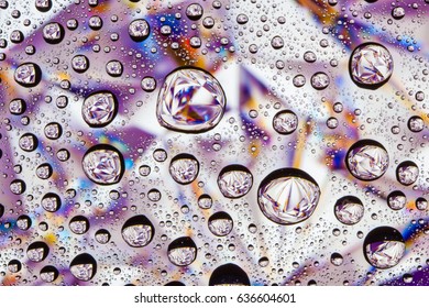 Abstract lines through drops of water on a glass macro