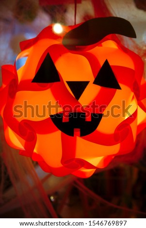 Abstract lit jack-o-lantern in a window.
