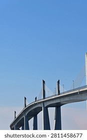 Abstract low angle vertical view of a modern large concrete cable stayed bridge with clear blue sky, Fukushima Japan.