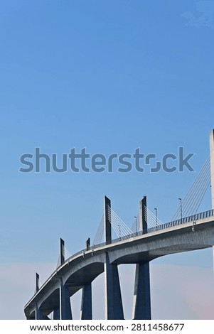 Abstract low angle vertical view of a modern large concrete cable stayed bridge with clear blue sky, Fukushima Japan.