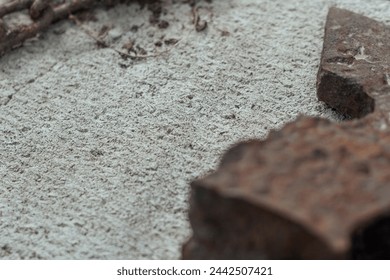 Abstract of Lumberman tools with broken rusted axe, head, chain on a gas silicate block