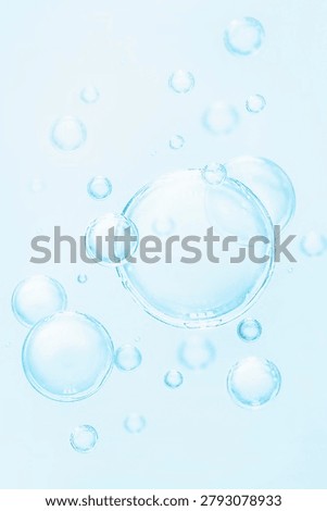 Abstract macro background of clean blue cosmetic serum bubbles under bright light. Moisturizing and skincare concept.