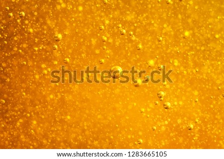 Abstract macro honey bubbles closeup in bright amber color. The texture of the honey. Healthy food concept. Diet. Selective focus.