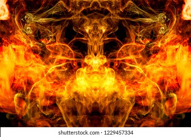 Abstract magic background. Cloud of  yellow and orange smoke in the form of a skull, monster, dragon on a black isolated background. 
