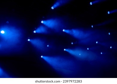 abstract magic image with rays of colored light from the spotlights in the dark