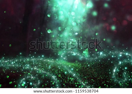 Abstract and magical image of glitter Firefly flying in the night forest. Fairy tale concept