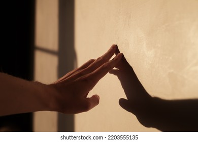 Abstract Man Hand Touch Wall With Sunset Light And Long Shadows, Shallow Focus