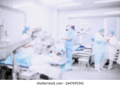 Abstract medical blurred background of operating room, patient lies on table, doctors working.