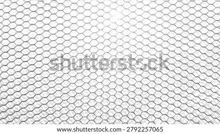 ​White abstract mesh texture background, close up of plastic net or hexagonal grid pattern with light gradient.