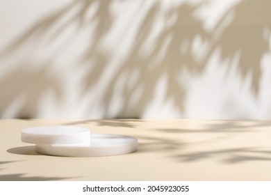 Abstract minimal nature scene - empty stage and circle podiums on beige background and soft shadows of tree leaves. Pedestal for cosmetic product and packaging mockups display presentation - Shutterstock ID 2045923055