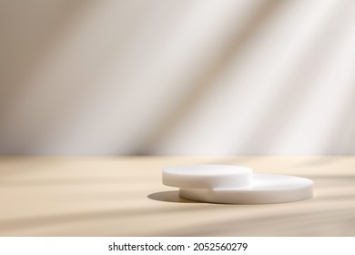 Abstract minimal nature scene - empty stage and circle podiums on beige background and soft shadows of tree leaves. Pedestal for cosmetic product and packaging mockups display presentation - Shutterstock ID 2052560279