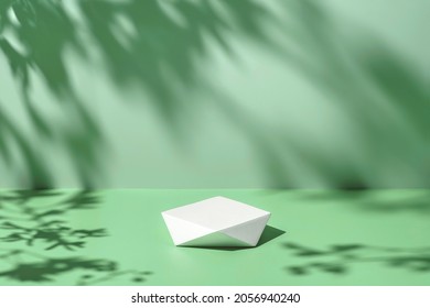 Abstract minimal nature scene - empty stage and polygonal podium on pastel mint green background and soft tree leaves shadows. Pedestal for cosmetic product and packaging mockups display presentation - Shutterstock ID 2056940240