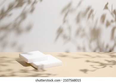 Abstract minimal nature scene - empty stage and square podium on beige background and soft shadows of tree leaves. Pedestal for cosmetic product and packaging mockups display presentation - Shutterstock ID 2107568015
