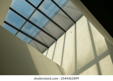 Abstract, minimalist, modern architectural space with concrete walls and opening skylight - Powered by Shutterstock