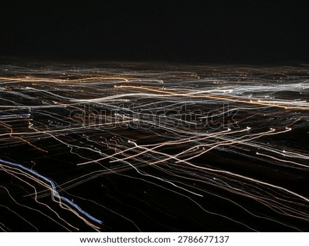 abstract mixture of parallel light tracks of a city crossing by a double exposure