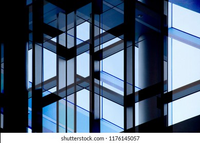 Abstract modern architecture background. Multiple exposure photo of office building windows against clear blue sky. Structural glazing. Glass wall with steel or aluminum framework. - Shutterstock ID 1176145057