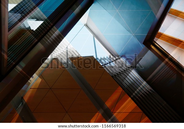 Abstract modern\
architecture background with reflections and shadows. Reworked\
photo of office interior fragment with geometric structure\
featuring louvers and dropped\
ceiling.