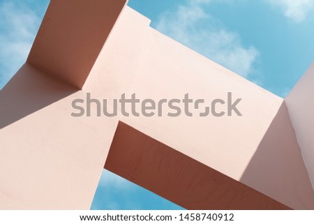 Abstract modern architecture fragment, background photo of a pink facade structures under blue sky at sunny day