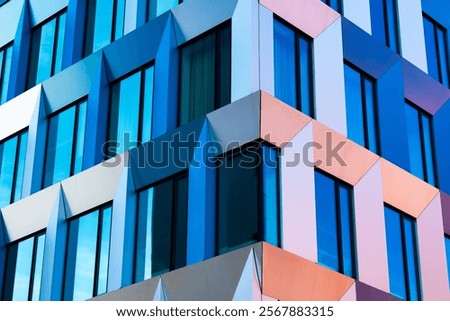 Abstract Modern Facade with Geometric Patterns, Blue and Yellow Panels, and Sunlight Reflections
